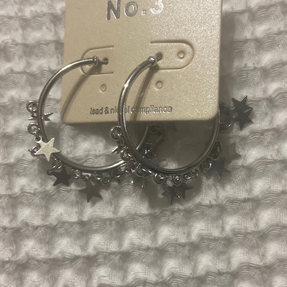 Silver hoop earrings with dangling stars